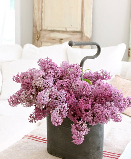 Artificial flowers in rustic old containers