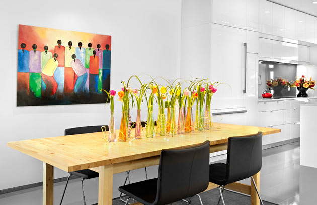 Artificial flowers in a row of vases