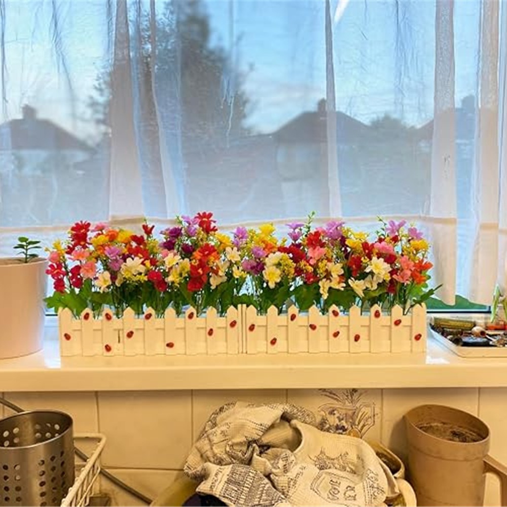 Customer photograph of the two colourful daisy boxes together on an indoor kitchen windowsill