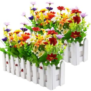 Pair of colourful artificial daisy window boxes in white picket-fence planters with ladybirds