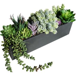 Mixed artificial succulents with green and purple leaves in a rustic black wooden trough