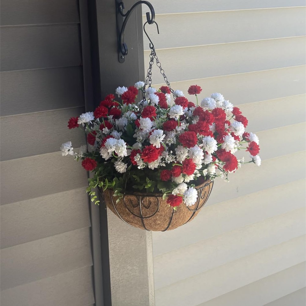 Red and white chrysanthemum-style flowers in a coconut-lined basket on a customer porch