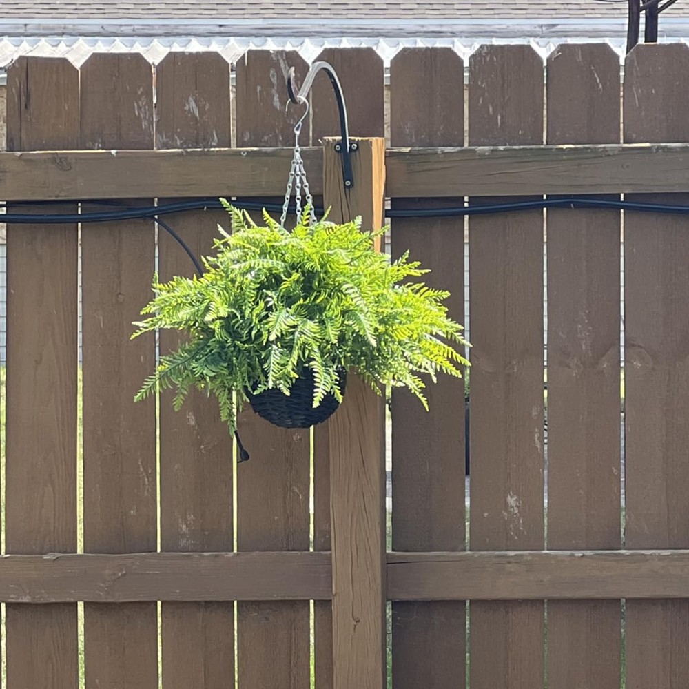 Customer photograph of a Juxdp artificial fern basket hanging on a timber fence