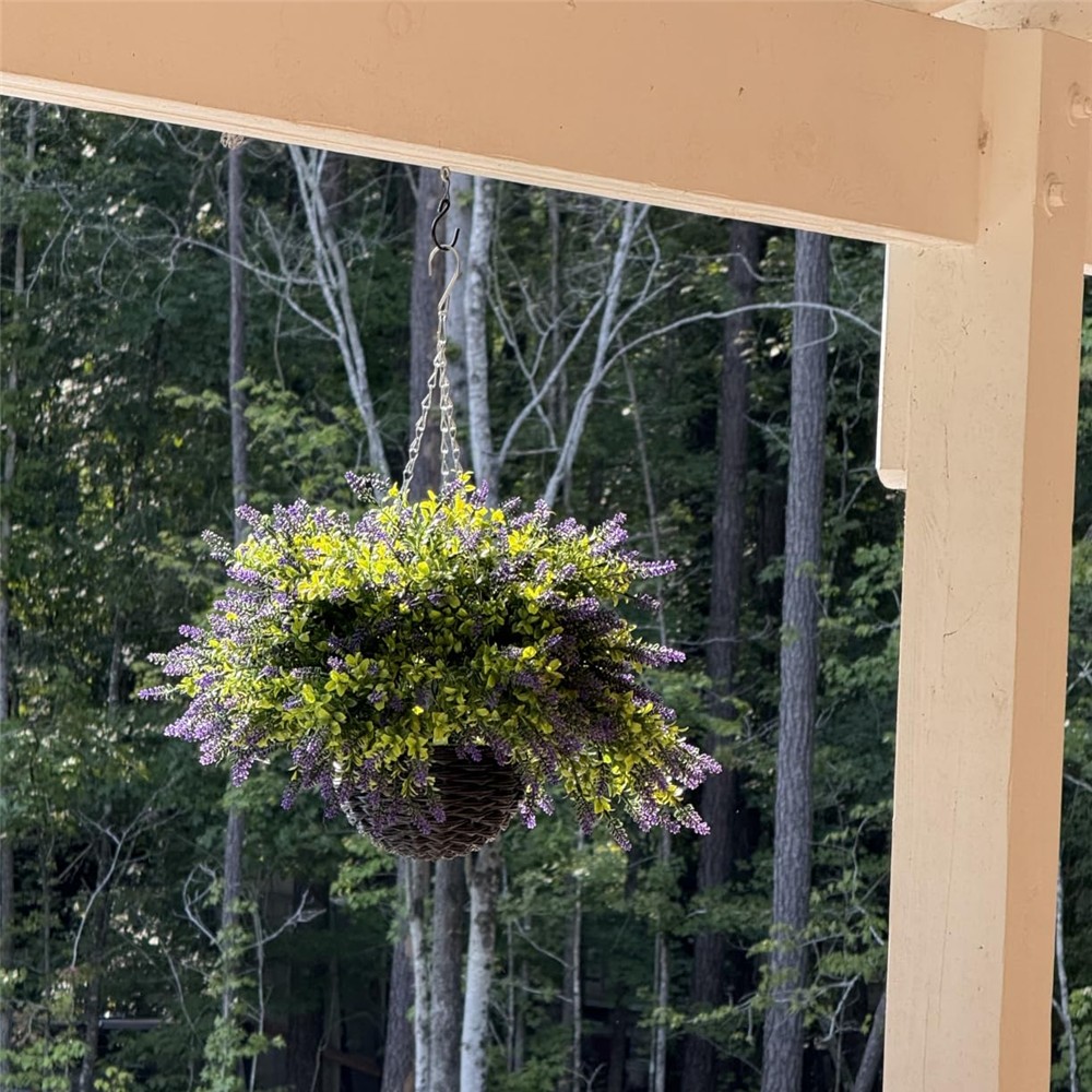 Customer photograph of the purple lavender and boxwood basket hanging beneath a porch