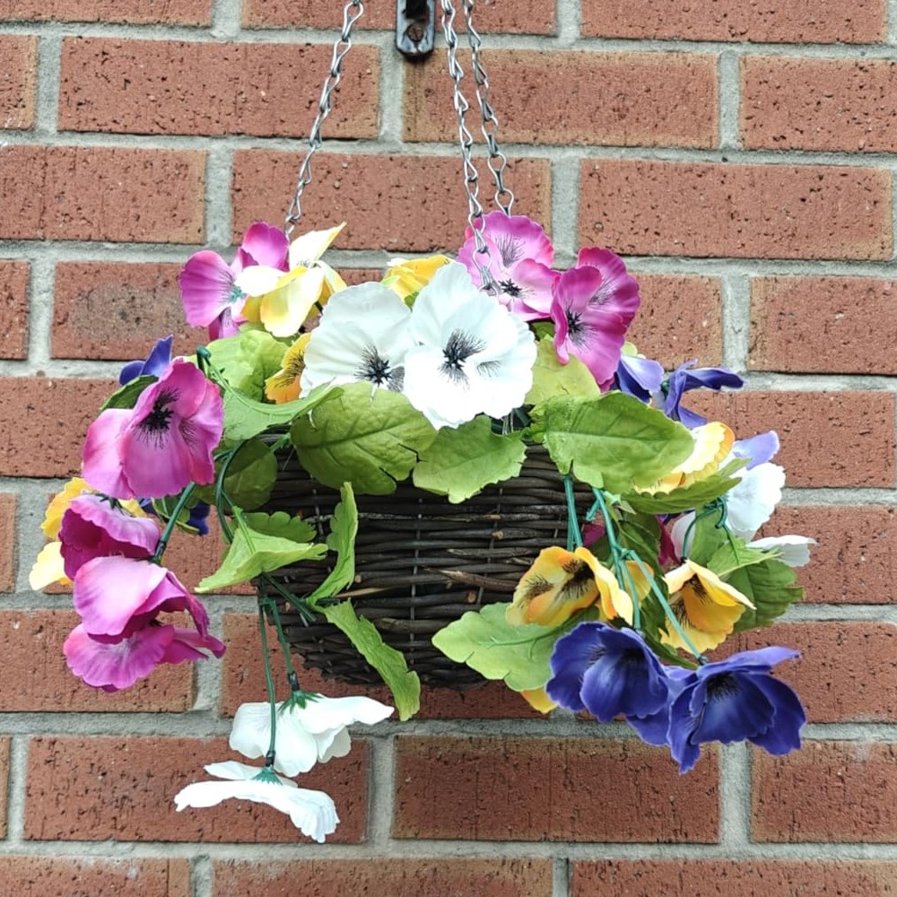 Customer photograph of an Oypla pansy hanging basket against a brick wall