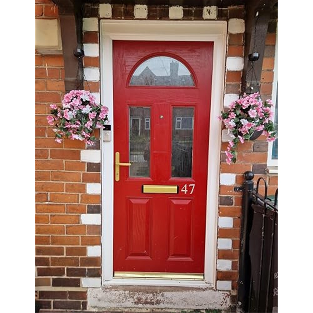 Customer photo showing pink and white solar flower baskets beside a red front door