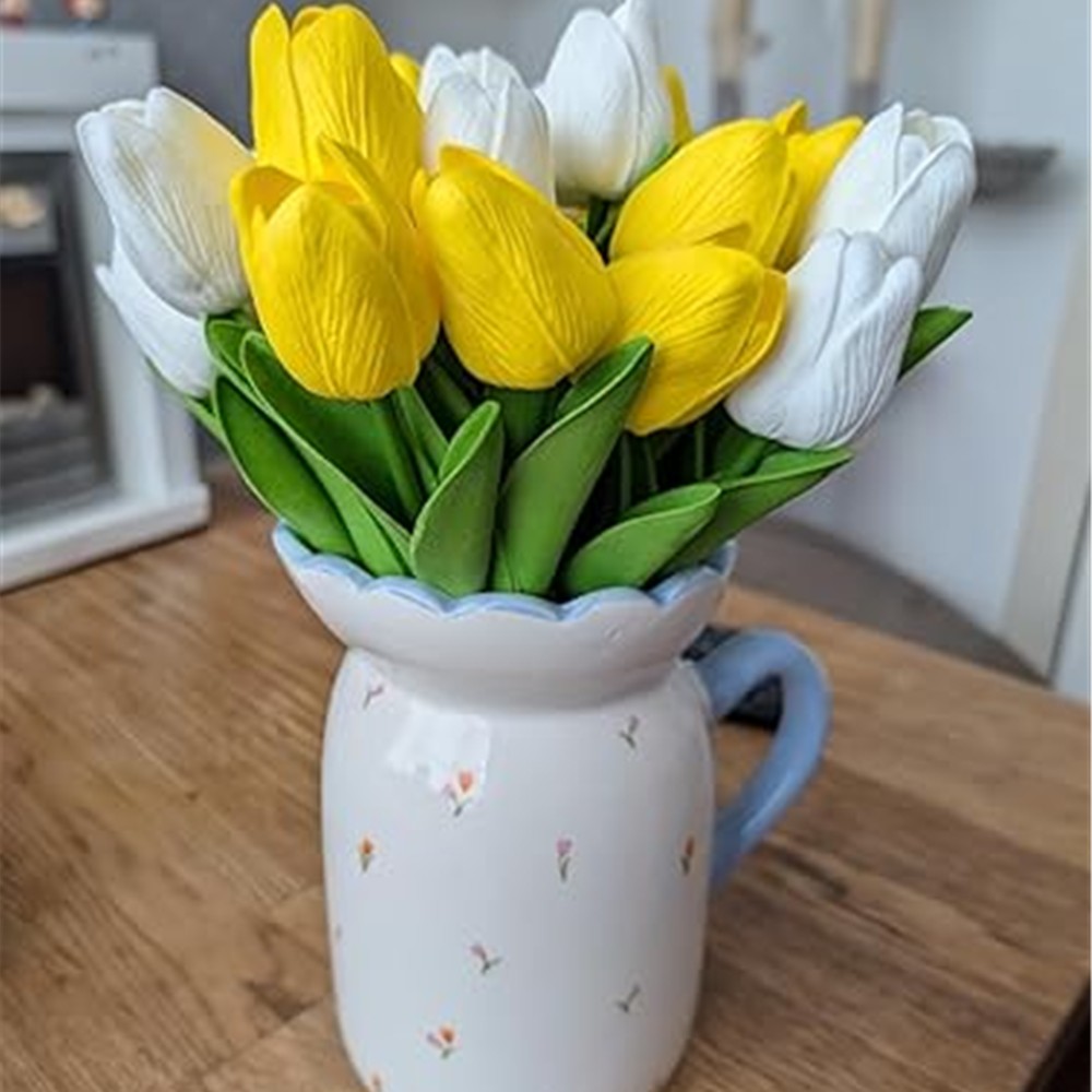 Customer arrangement combining yellow and white artificial tulips in a jug