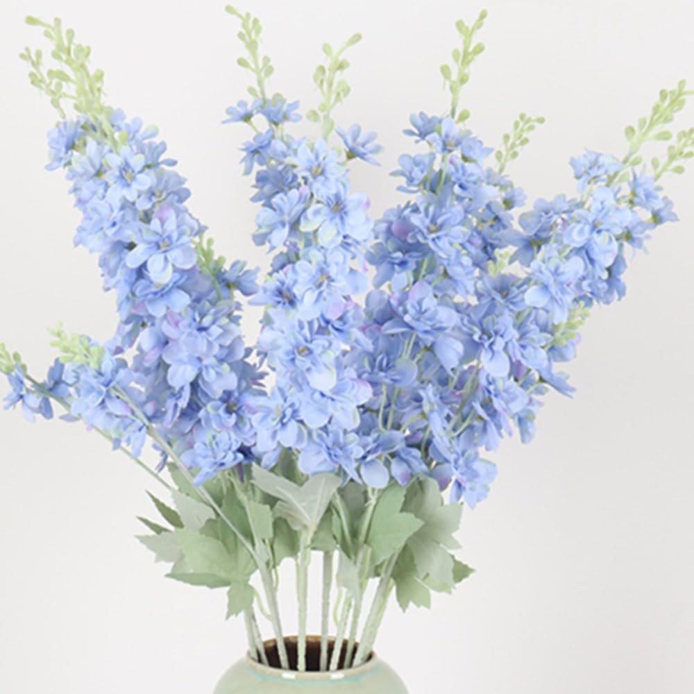 Pale blue artificial delphinium sprays with tall flower spikes and soft green leaves