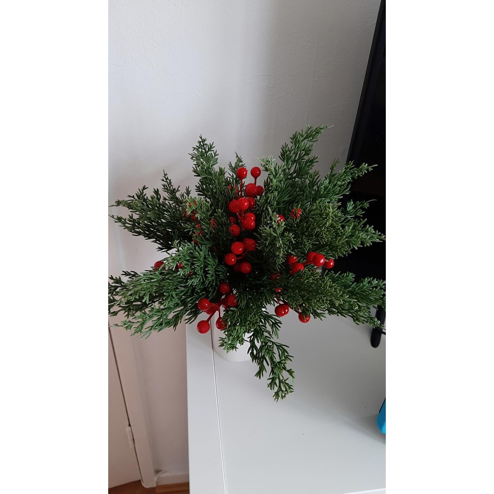 Customer display: Christmas pine and red berry arrangement with a cream ceramic vase
