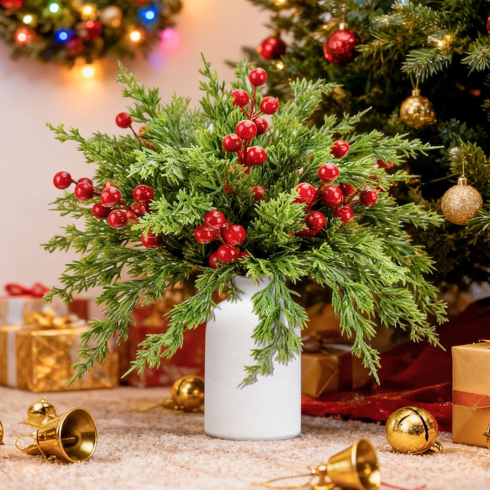 Christmas pine and red berry arrangement with a cream ceramic vase