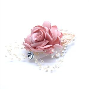 Pink satin rose wrist corsage with pearls and a gold leaf
