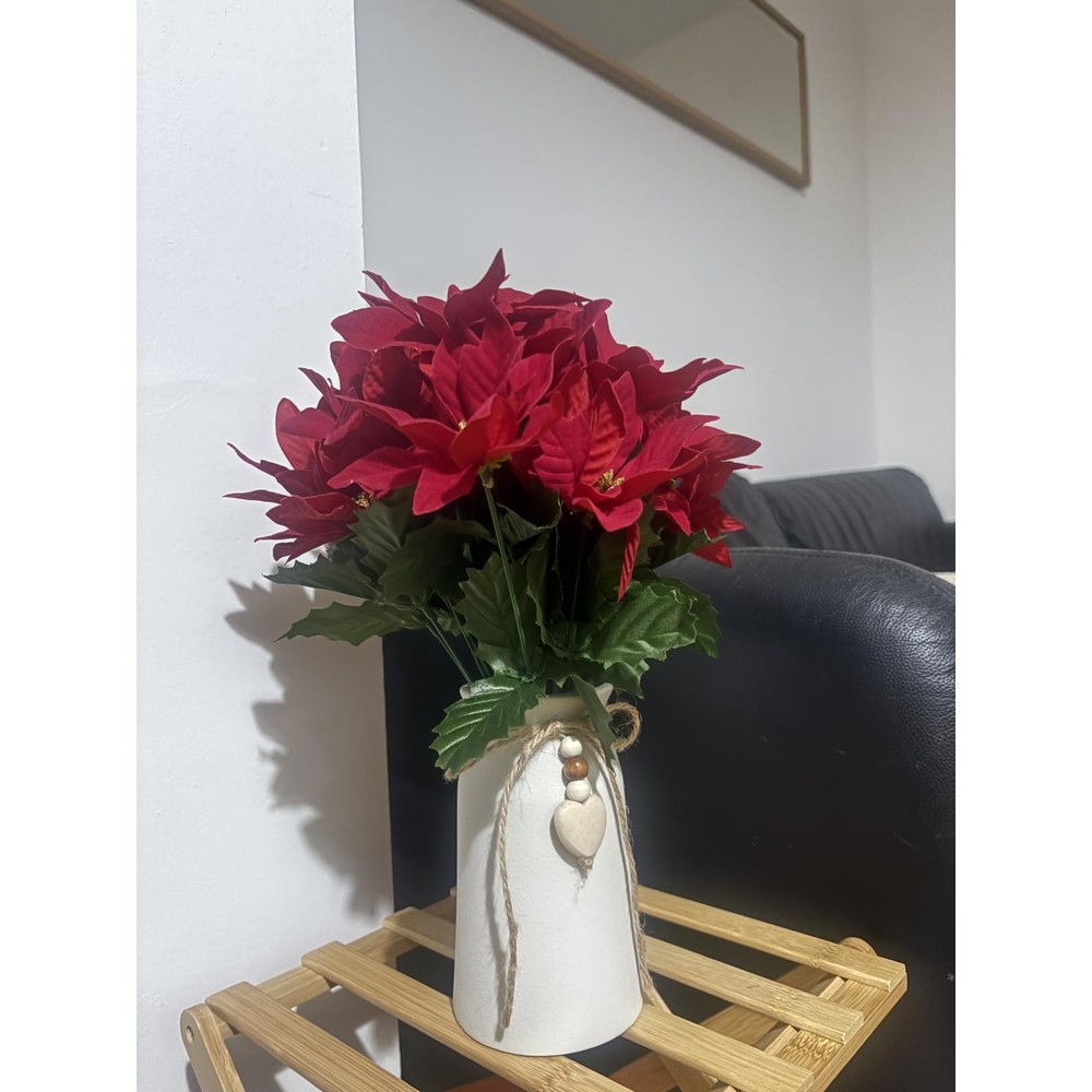 Customer display: Red artificial poinsettias in a white heart-charm vase