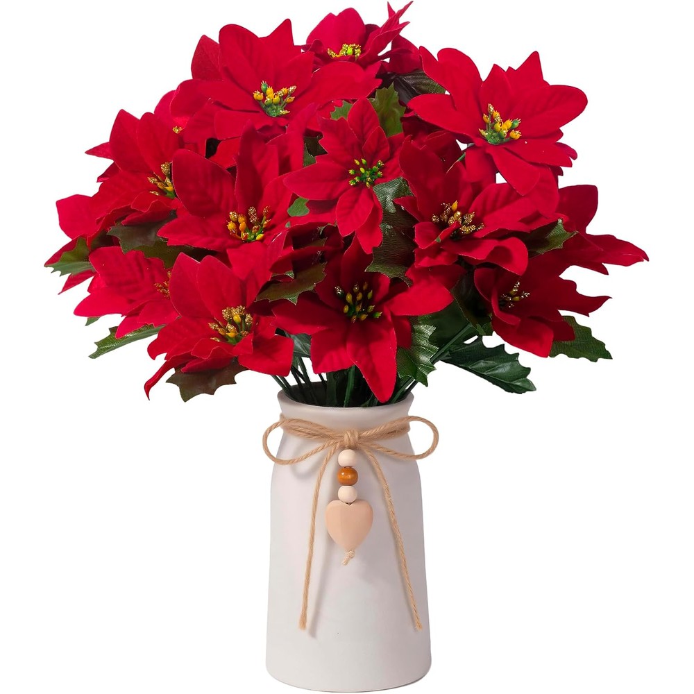 Red artificial poinsettias in a white heart-charm vase
