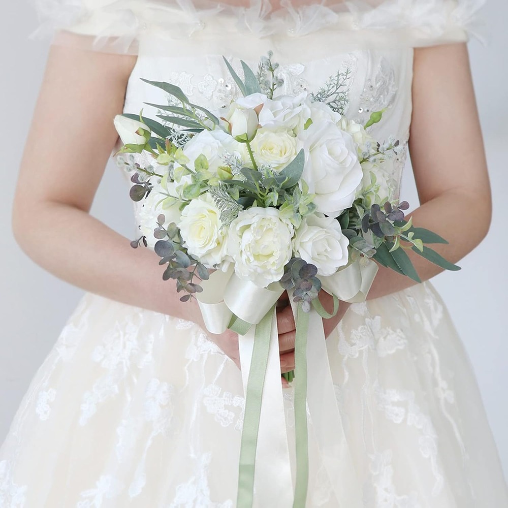 White artificial rose bridal bouquet with soft green foliage