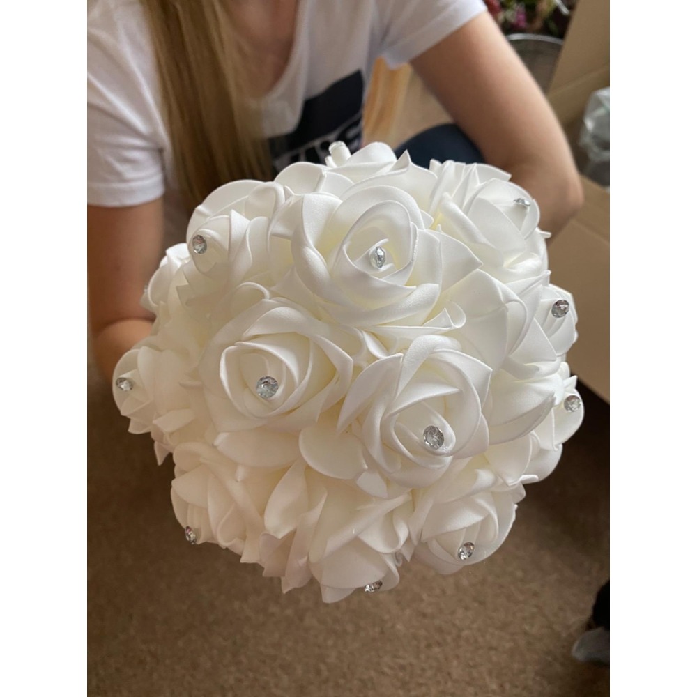 Customer photo: White artificial rose wedding bouquet with a satin bow and diamante detail